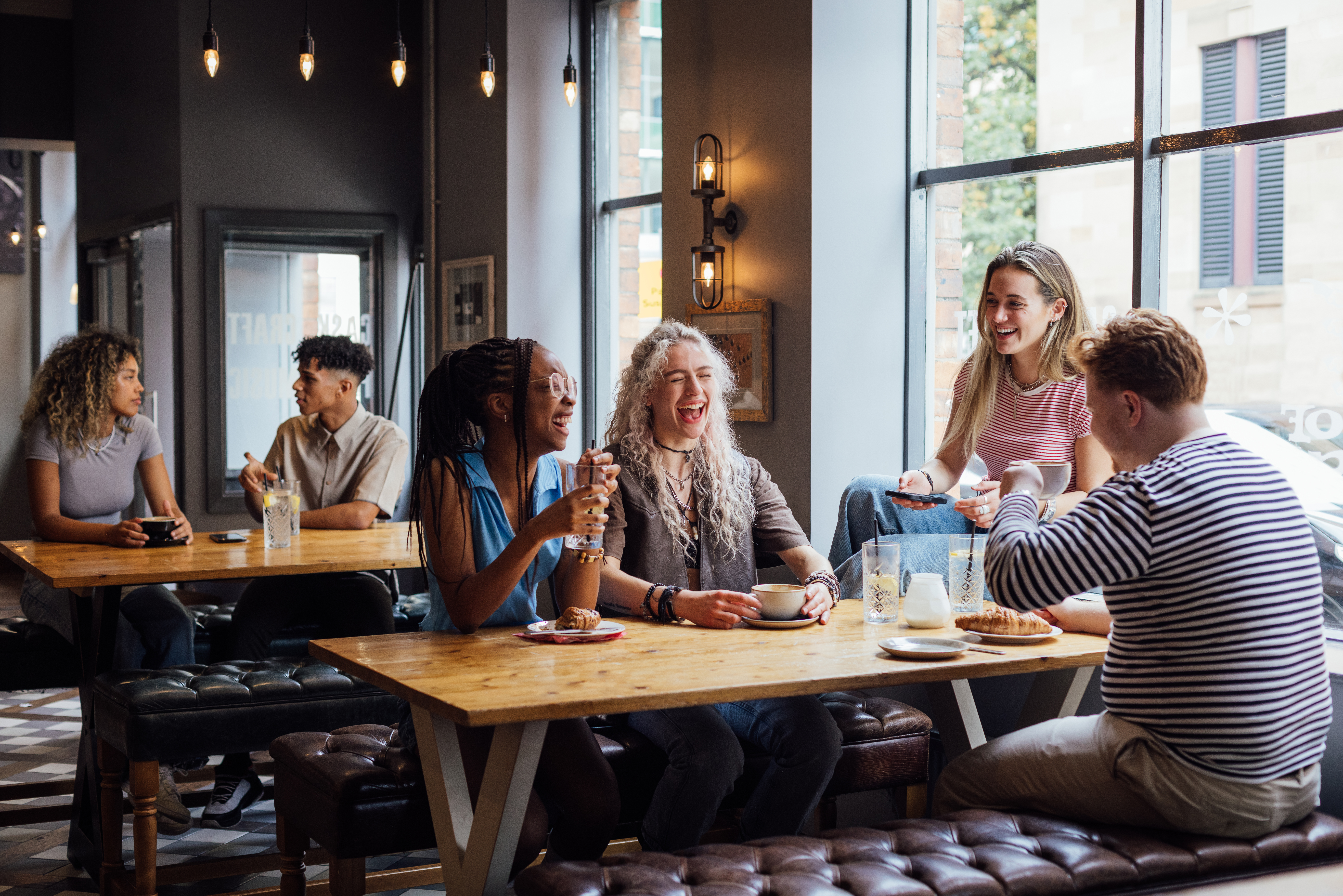People laughing together at a cafe